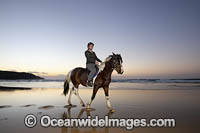 Horse riding on beach. Coffs Harbour, New South Wales, Australia.