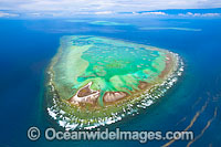Aerial view of One Tree Island and reef, with Wistari Reef, Heron Island Reef and Sykes Reef visible in background. One Tree Island is a small coral cay located near the Tropic of Capricorn, Sth Great Barrier Reef, Australia. Note Red Tide Algal Bloom.