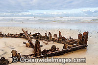Historic Shipwreck 'Buster' on Woolgoolga beach, New South Wales. Vessel was blown ashore & beached during a violent storm in Feb 1893. Class: Barquentine. Construction: Timber single deck & 3 masts. Built: Nova Scotia, Canada 1884. Length - 129 ft
