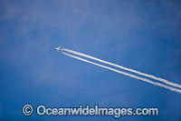 Qantas Jet flying high in the sky, showing the vaporised jet stream made by the jets engines. New South Wales, Australia.