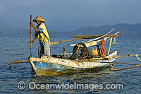Indonesian fisherman in a traditional fishing boat known as Jukung. Indonesia.