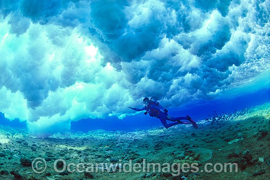 Scuba Diver breaking wave Coral reef photo