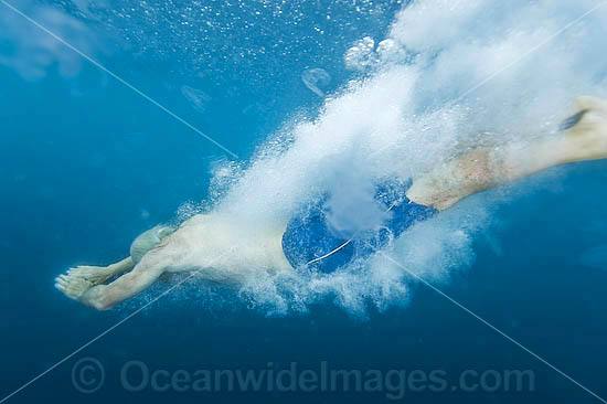 Man diving into ocean photo