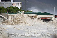 Wave breaking over house Photo - Chris and Monique Fallows