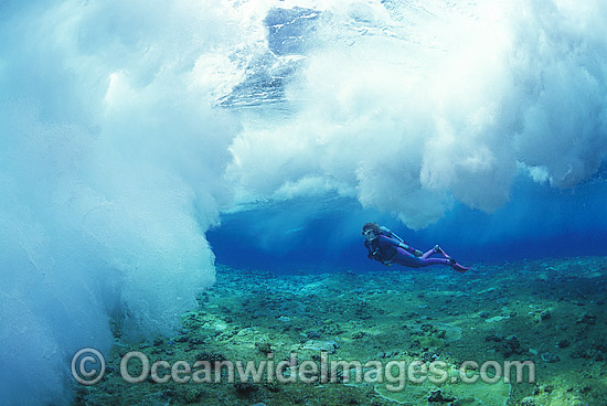 Scuba Diver breaking wave Coral reef photo