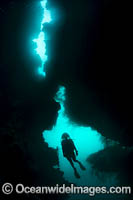 Diver exploring an underwater sea cavern. Kimbe Bay, Papua New Guinea.