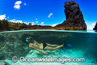 Snorkel diver exploring a tidal rock pool at Christmas Island, Indian Ocean, Australia.