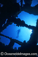 Scuba Diver exploring the historic SS Yongala shipwreck. Situated off Cape Bowling Green, near Townsville, Queensland, Australia.