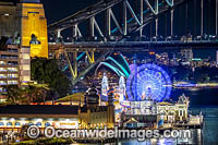 Sydney Harbour Bridge, Luna Park and City decorated in light during Vivid Sydney's 2018 festival of light, music and ideas. Sydney, New South Wales, Australia.