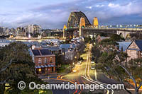 Sydney Harbour Bridge, Luna Park and City during dusk. Sydney, New South Wales, Australia.
